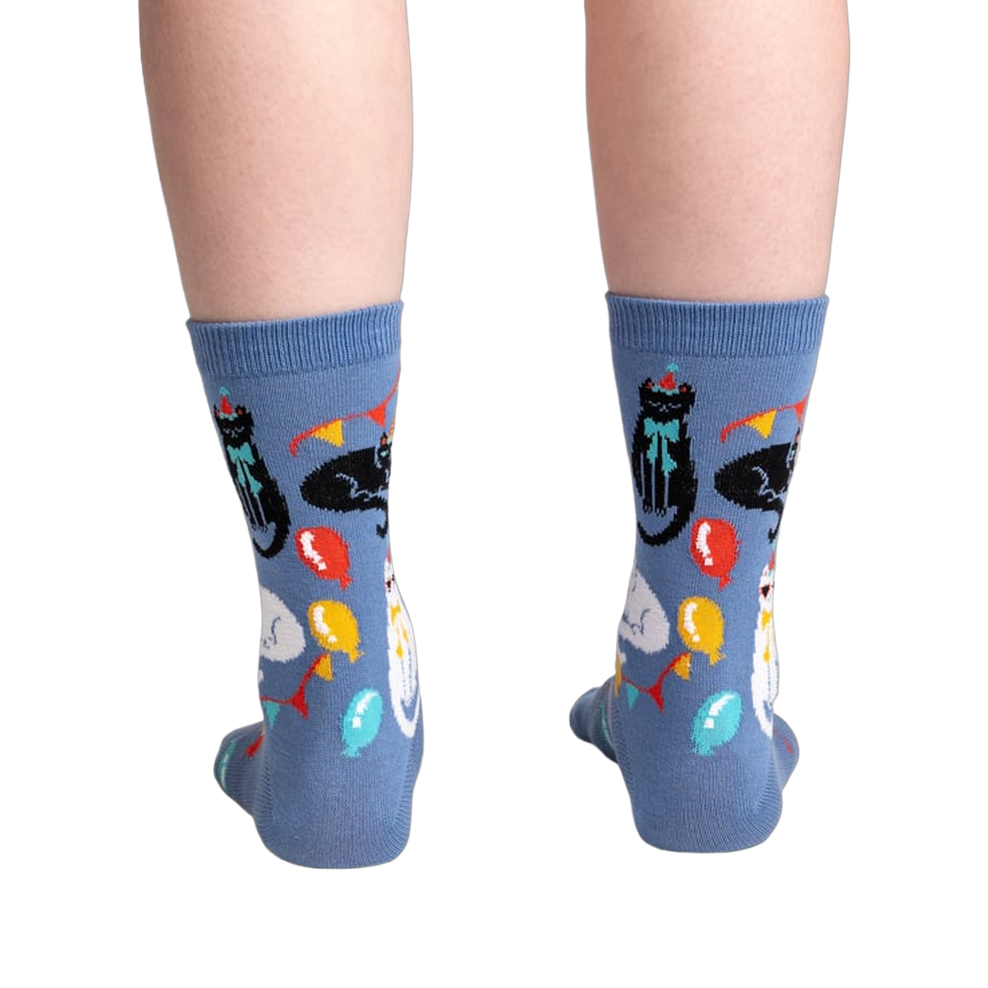 Back view of the socks showing the full design.  Blue crew socks with cats and party items.