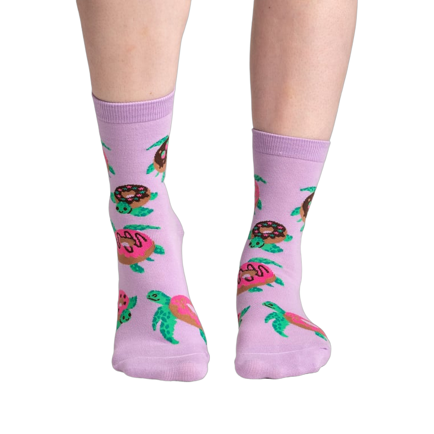 Lifestyle shot of model wearing a pair of lavender crew socks with turtles and donuts.