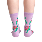 Back view of the same socks, showing the donut-turtle pattern.