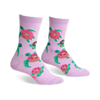Pair of lavender crew socks with repeating pattern of turtles carrying pink donuts. Fun and quirky design.