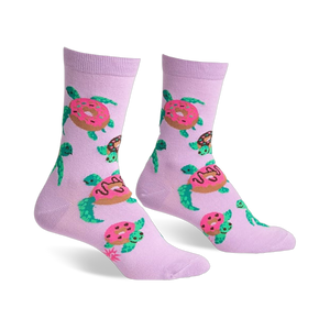 Pair of lavender crew socks with repeating pattern of turtles carrying pink donuts. Fun and quirky design.