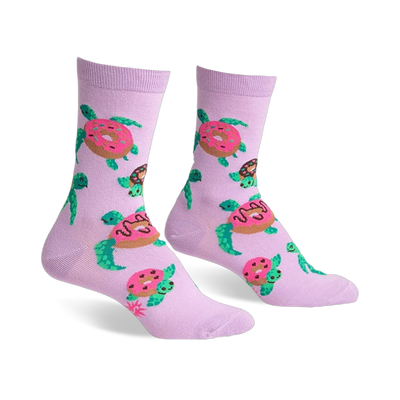 Pair of lavender crew socks with repeating pattern of turtles carrying pink donuts. Fun and quirky design.
