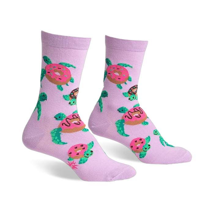 Pair of lavender crew socks with repeating pattern of turtles carrying pink donuts. Fun and quirky design.