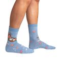 Lifestyle shot showing the 'Be Your-shell-f Shimmer' socks on a person's legs against a black background.