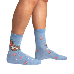 Lifestyle shot showing the 'Be Your-shell-f Shimmer' socks on a person's legs against a black background.