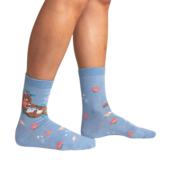 Lifestyle shot showing the 'Be Your-shell-f Shimmer' socks on a person's legs against a black background.
