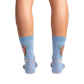 Rear view of the socks on a model's legs against a black background, showcasing the full design.