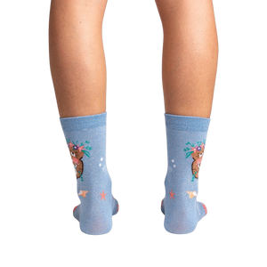 Rear view of the socks on a model's legs against a black background, showcasing the full design.