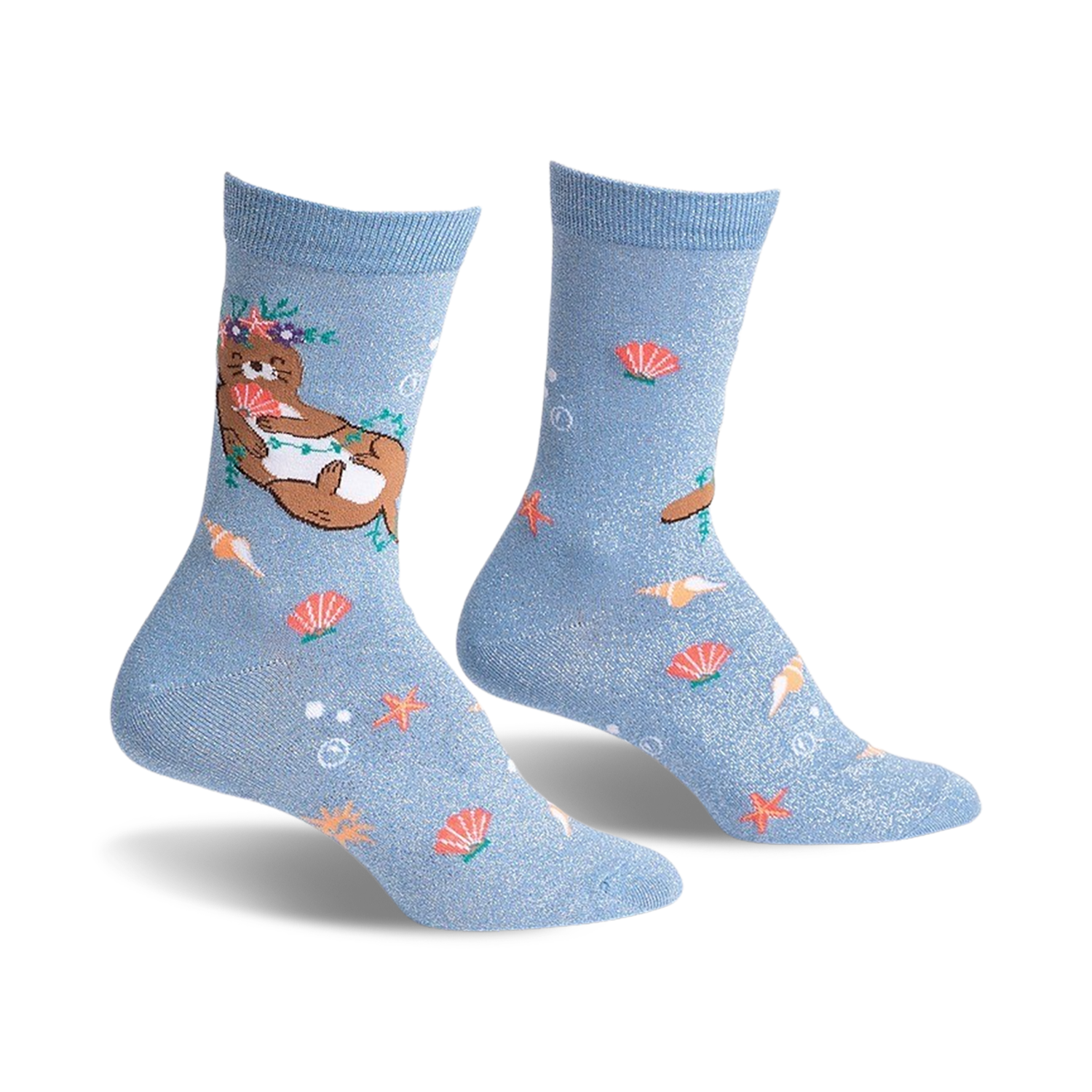 Pair of light blue crew socks with a whimsical design.  Features a flower-crowned otter, seashells, starfish, and subtle shimmer.