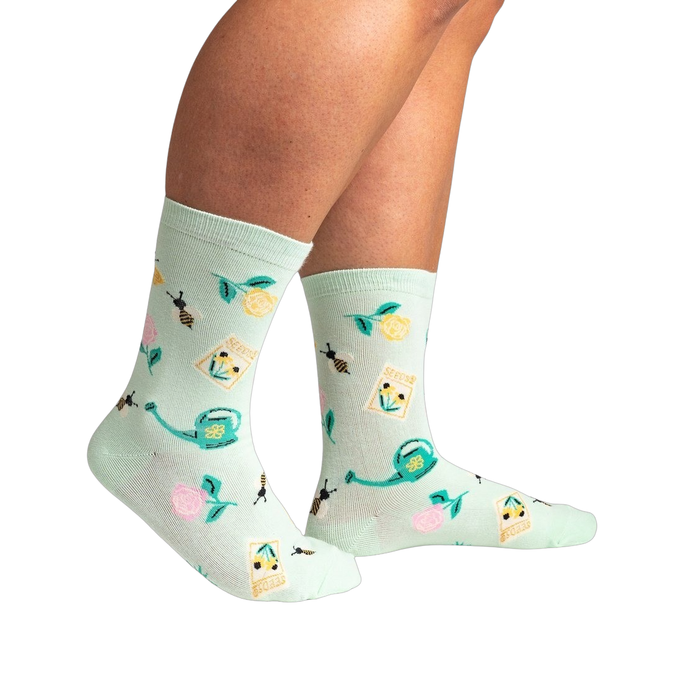Lifestyle shot of a person wearing the mint green 'Sow in Love' socks, showcasing how they look when worn.
