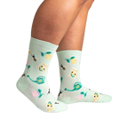 Lifestyle shot of a person wearing the mint green 'Sow in Love' socks, showcasing how they look when worn.