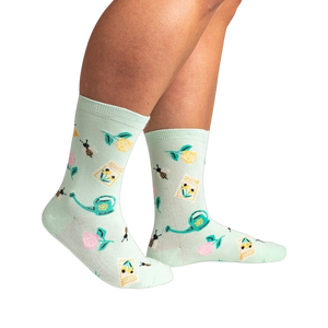 Lifestyle shot of a person wearing the mint green 'Sow in Love' socks, showcasing how they look when worn.