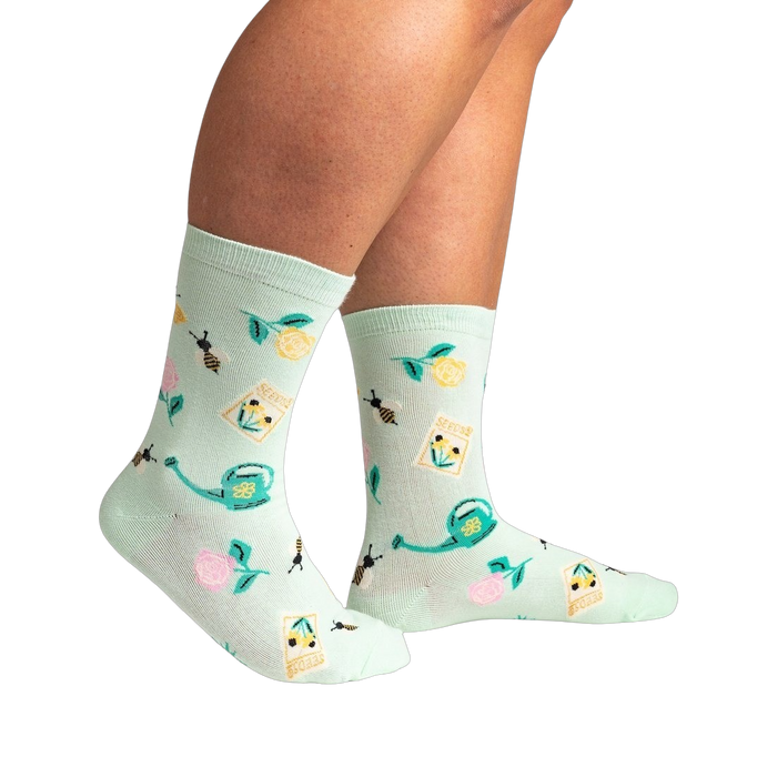 Lifestyle shot of a person wearing the mint green 'Sow in Love' socks, showcasing how they look when worn.