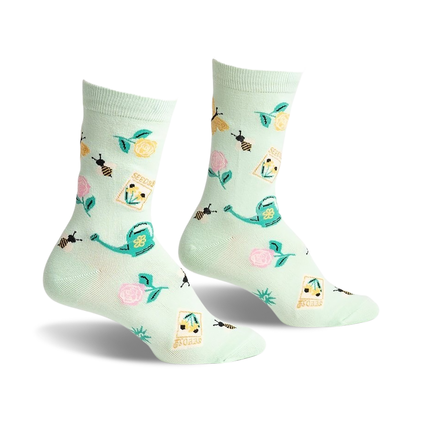 Pair of mint green crew socks with a whimsical garden design. Features bees, flowers, seed packets, and watering cans.