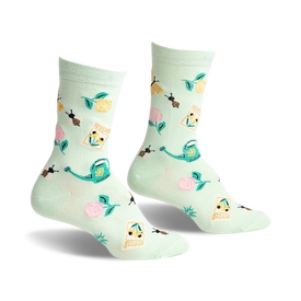 crew-length women's gardening socks with flower, bee, watering can, and seed packet patterns on a light green background.  