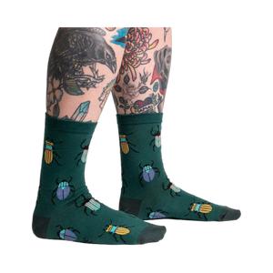 Lifestyle shot: Beetle-Mania! socks on a model's legs, showcasing the fit and design.