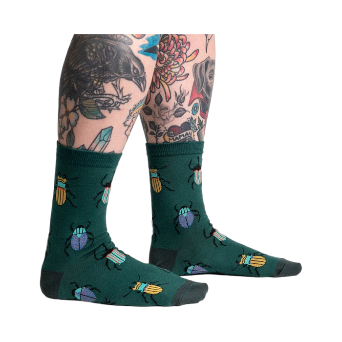 Lifestyle shot: Beetle-Mania! socks on a model's legs, showcasing the fit and design.