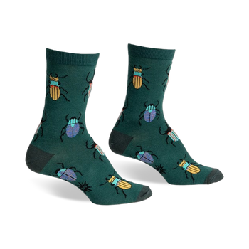 A pair of green crew socks with a whimsical pattern of colorful beetles. Yellow and blue beetles are scattered on a dark-green background.