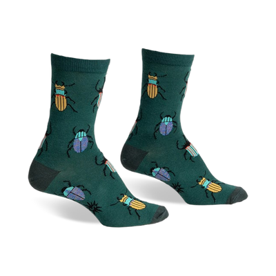 A pair of green crew socks with a whimsical pattern of colorful beetles. Yellow and blue beetles are scattered on a dark-green background.