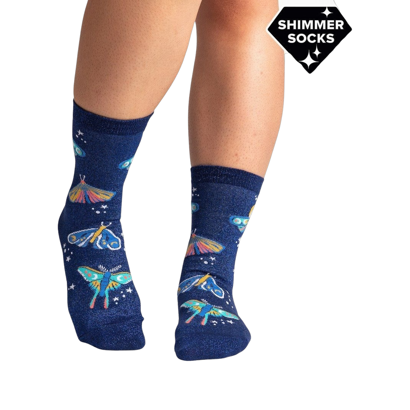 Lifestyle shot of a person's legs wearing the Moonlit Moth Shimmer socks, showing the socks on feet.