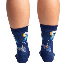 A pair of blue socks with a pattern of moths and crescent moons.
