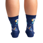 Back view of a pair of Moonlit Moth Shimmer socks on a person's legs, showing the back of the socks.