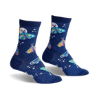 Pair of women's crew socks in dark blue glitter. Features whimsical moon and moth designs in pastel pinks, blues, and yellows.