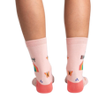 Back view of the socks on a model's legs, showcasing the design details on the back of the socks.