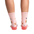 Back view of the socks on a model's legs, showcasing the design details on the back of the socks.