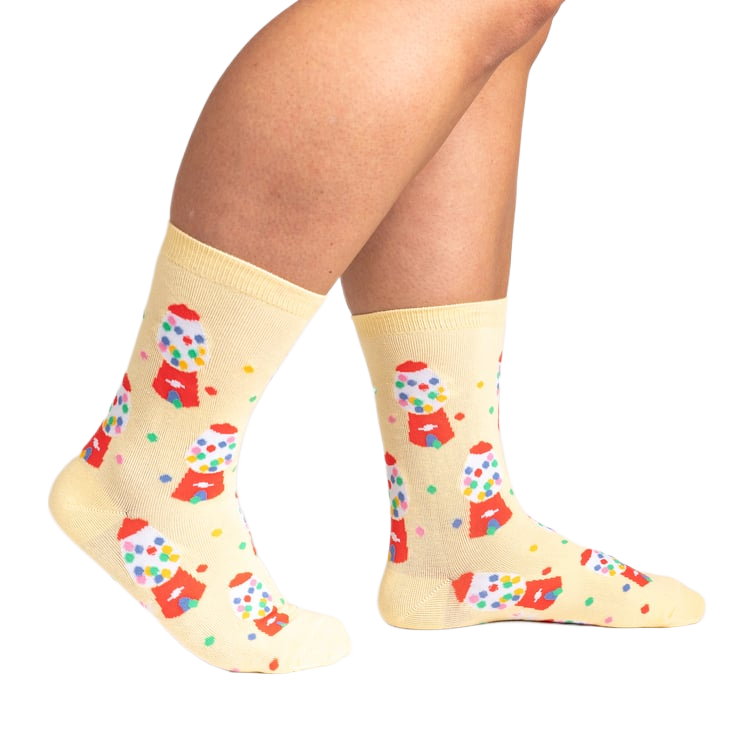 Lifestyle shot showing 'I Chews You' socks on a person's legs.