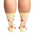 Back view of 'I Chews You' socks on a person's legs.