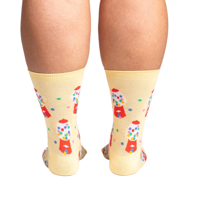 Back view of 'I Chews You' socks on a person's legs.