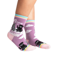 Lifestyle shot of Paws + Reflect socks on a person's legs, showcasing the sock's fit and design.