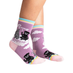 Lifestyle shot of Paws + Reflect socks on a person's legs, showcasing the sock's fit and design.