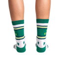 Rear view of the socks on a person's legs.  Shows the back design of the socks against a black background.