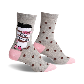 gray coffee bean patterned socks with pink toe and heel. left sock has cartoon coffee cup design with the words "fully caffeinated printed on it. womens. crew length.   