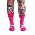 Lifestyle shot of a person's legs wearing Strawberry Milk socks, showcasing the socks on a model.