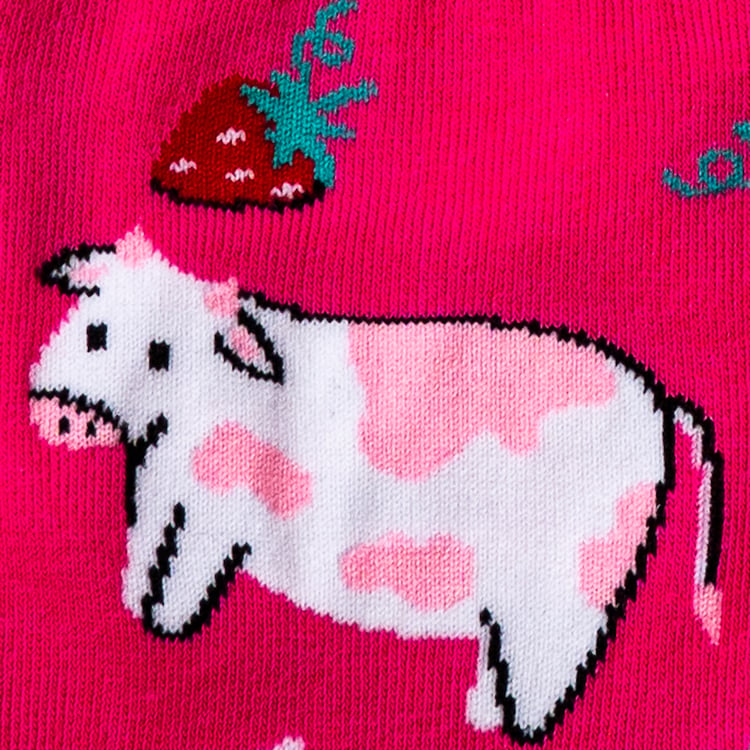 Close-up detail shot of a cow and strawberry design element from Strawberry Milk socks.