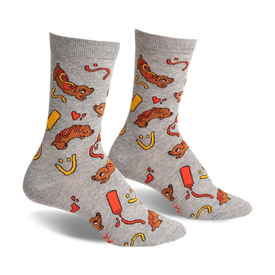 a pair of grey socks with a pattern of hot dogs, ketchup, mustard, and smiley faces. the socks are viewed from the side.