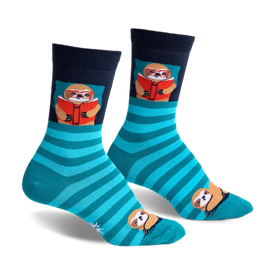 front view of a pair of socks. the socks have blue and green stripes, with a small sloth wearing glasses and reading a book on the front of each sock.  there is a small sloth in the toe of each sock.