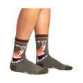 Lifestyle photo showing the socks on a person's legs. The socks are olive green with a corgi design.