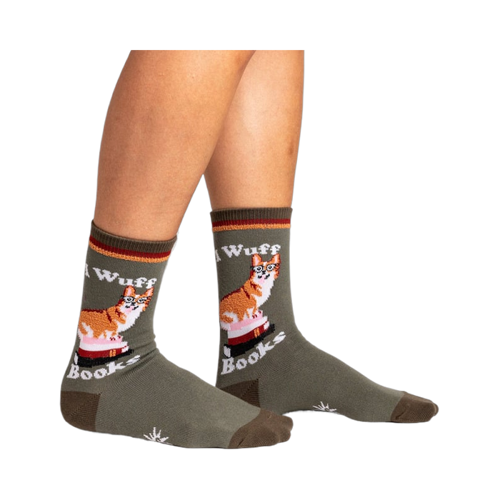 Lifestyle photo showing the socks on a person's legs. The socks are olive green with a corgi design.