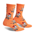 Pair of orange crew socks with a repeating pattern of chickens skateboarding.  The chickens wear sunglasses and red combs.
