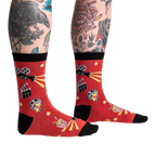 Lifestyle shot showing the socks on a person's legs with tattoos, showcasing the fit and style of the 'Movie Night' socks.
