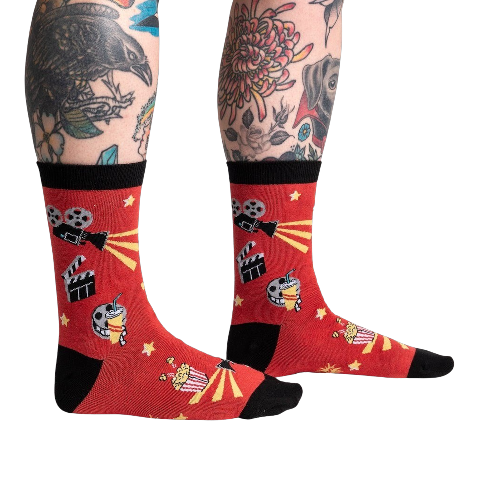 Lifestyle shot showing the socks on a person's legs with tattoos, showcasing the fit and style of the 'Movie Night' socks.