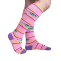 Lifestyle shot showing Rawr-ler Rink socks on a person's legs, showcasing the fit and pattern.