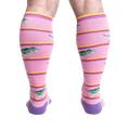 Rear view of a person wearing Rawr-ler Rink socks, highlighting the full sock design from the back.