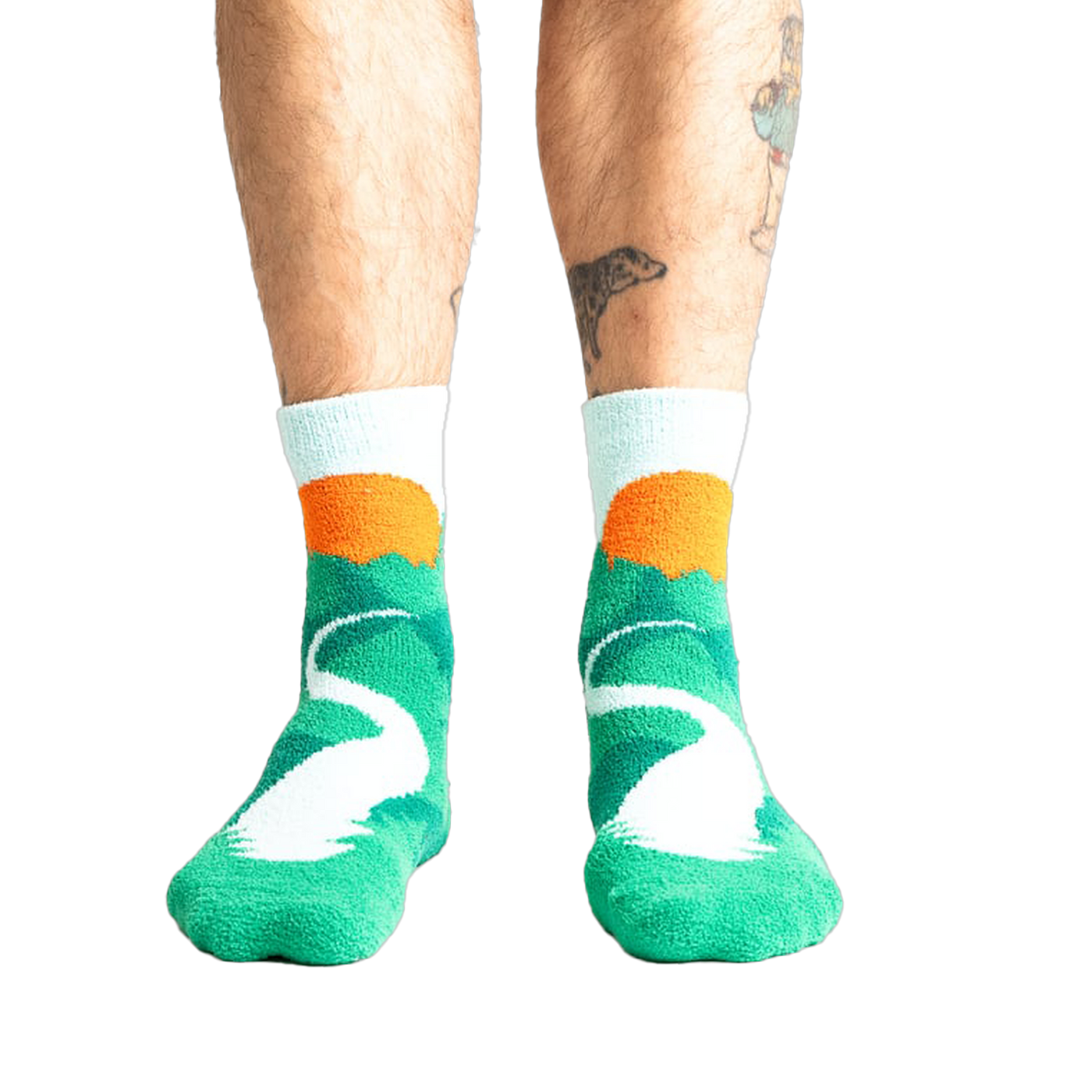 Lifestyle shot of a person's legs wearing the teal and light blue mountain slipper socks.