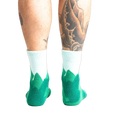 Back view of a person's legs wearing the teal and light blue mountain slipper socks, showcasing the non-slip soles.