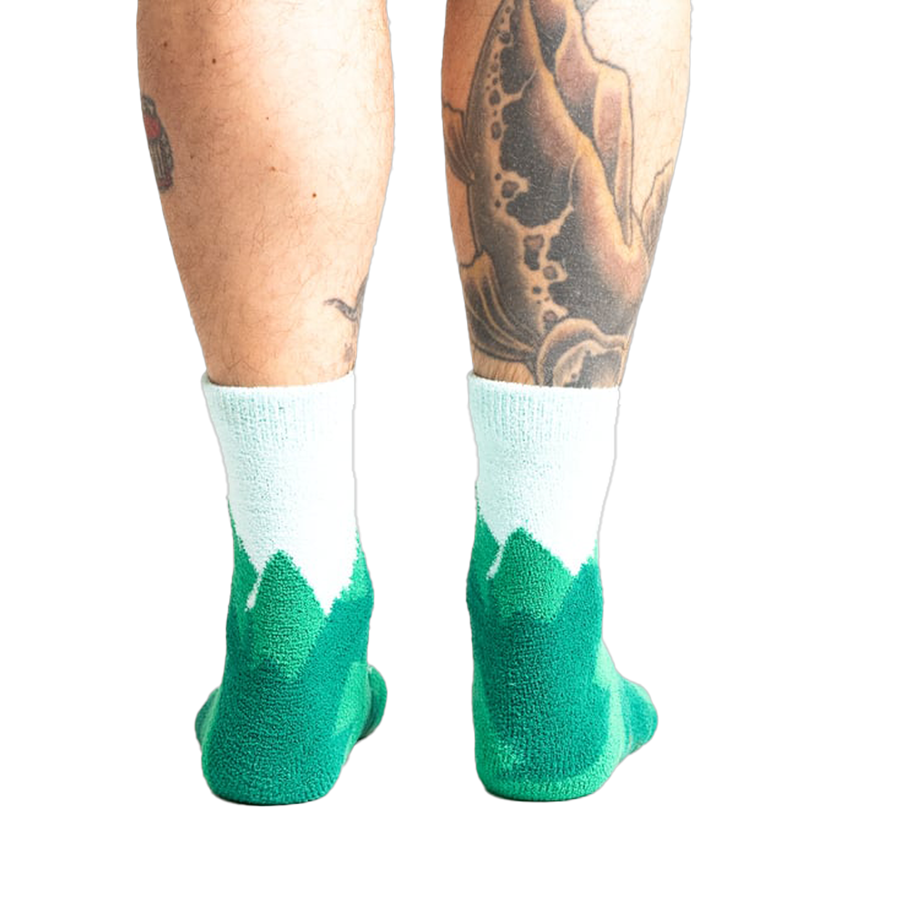 Back view of a person's legs wearing the teal and light blue mountain slipper socks, showcasing the non-slip soles.